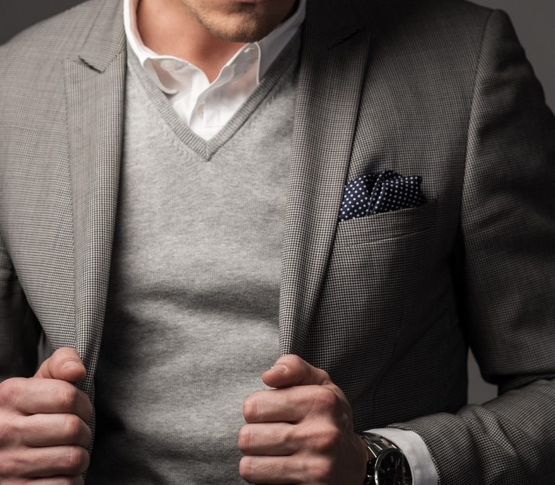 Man in grey sweater and suit jacket