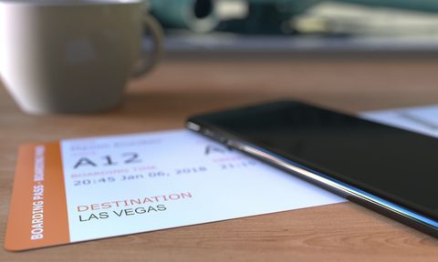Airline ticket to Las Vegas and cell phone on a table