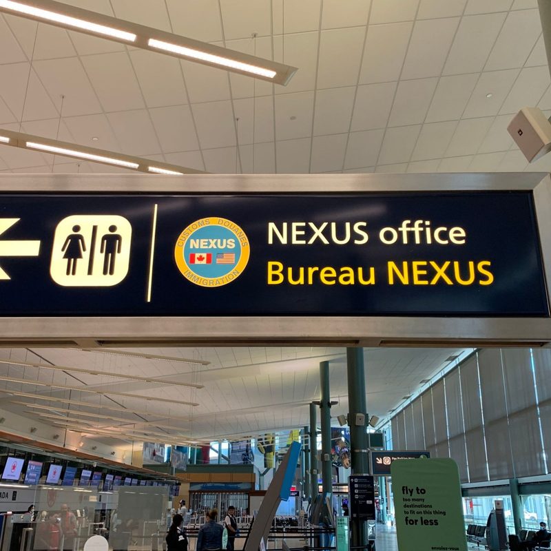 A sign pointing to Nexus office at airport