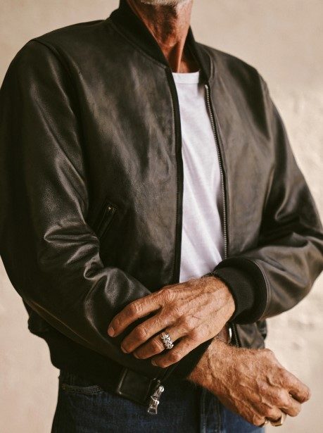 man wearing Buck Mason Bruiser Leather Bomber Jacket with white tshirt