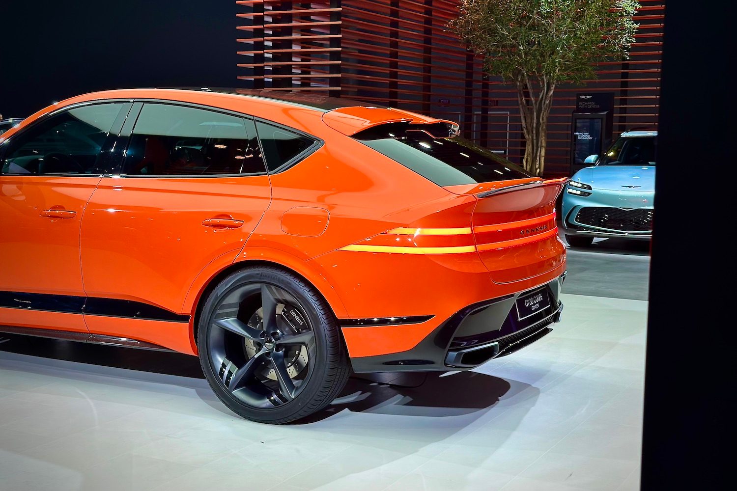 Rear end angle of the Genesis GV80 Coupe from the driver's side parked on as stage.