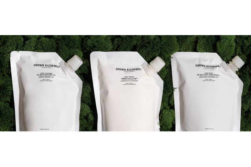 Grown Alchemist products in front of a tree and green image background.