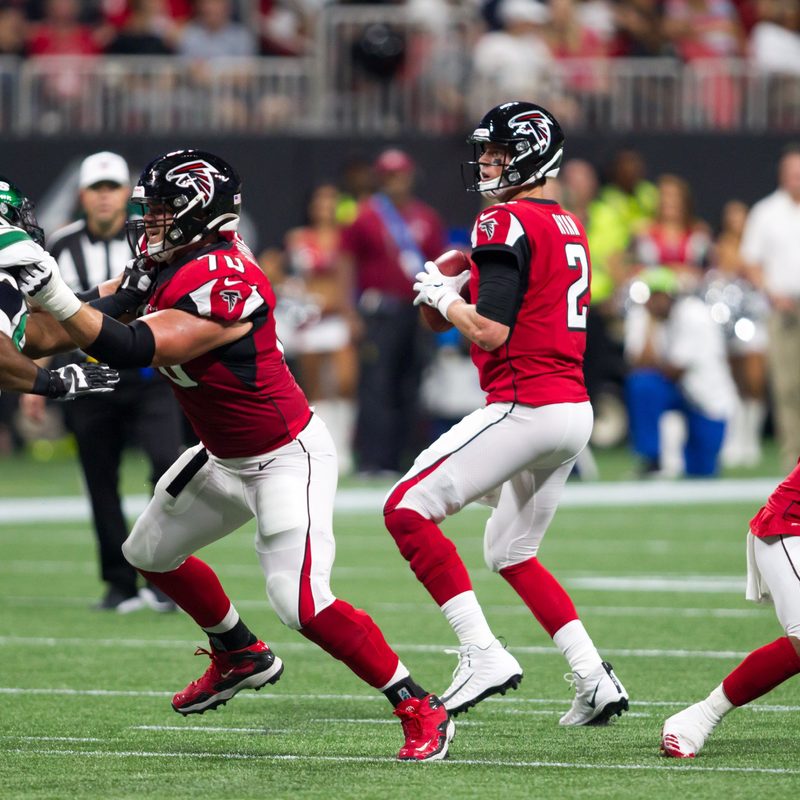 Quarterback throwing football in an NFL game