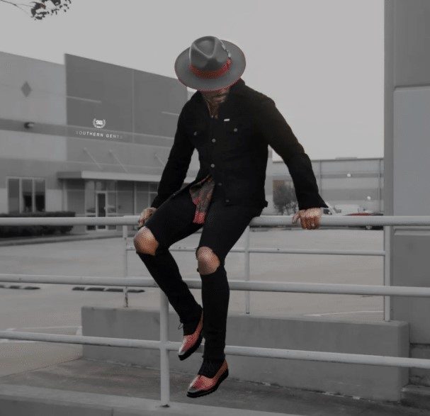 man wearing S-gents Suede jacket sitting on rail 