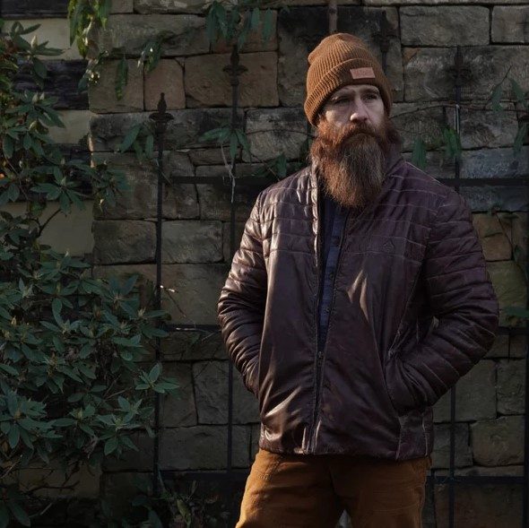Bearded man wearing the Savage Gentleman Leather Down Jacket