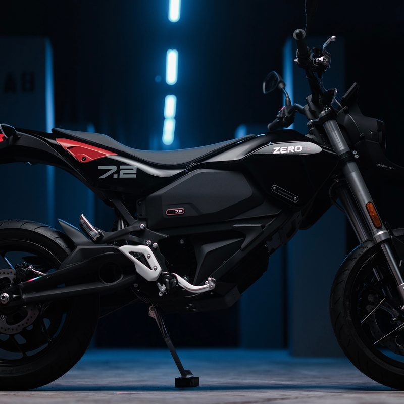 Zero FXE silhouette parked in a garage with blue lighting overhead.