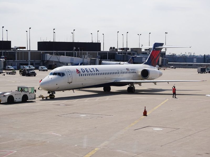 A Delta Airlines plane making ready to take off at the airport.