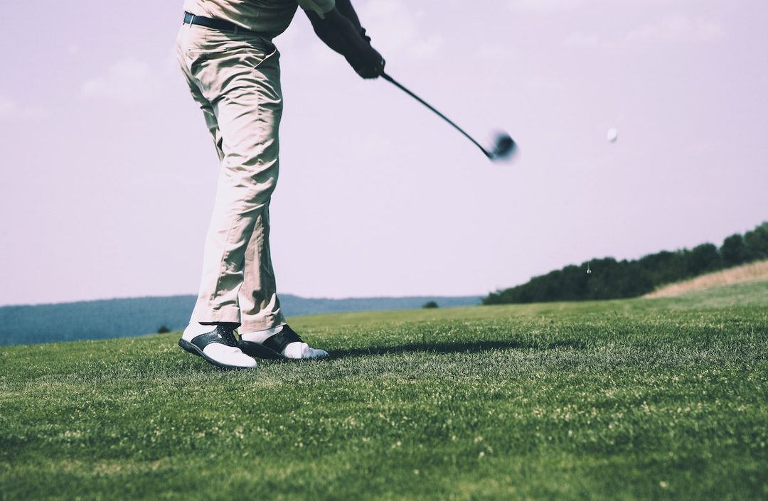 a person driving on a golf course