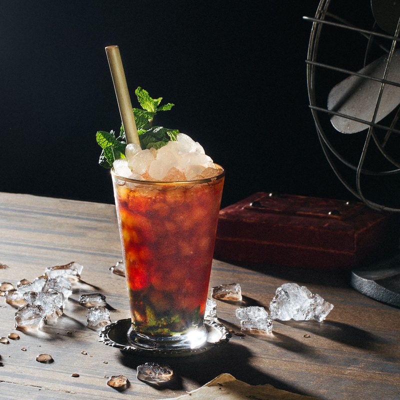 The Pathfinder Julep next to ice and a fan.