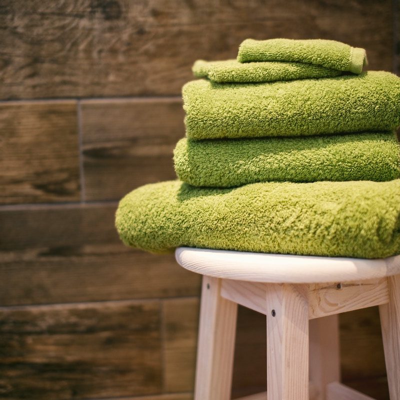 Green towels on a stool