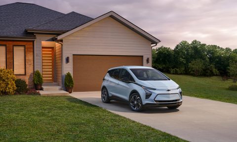2023 Chevrolet Bolt EV parked outside a home.