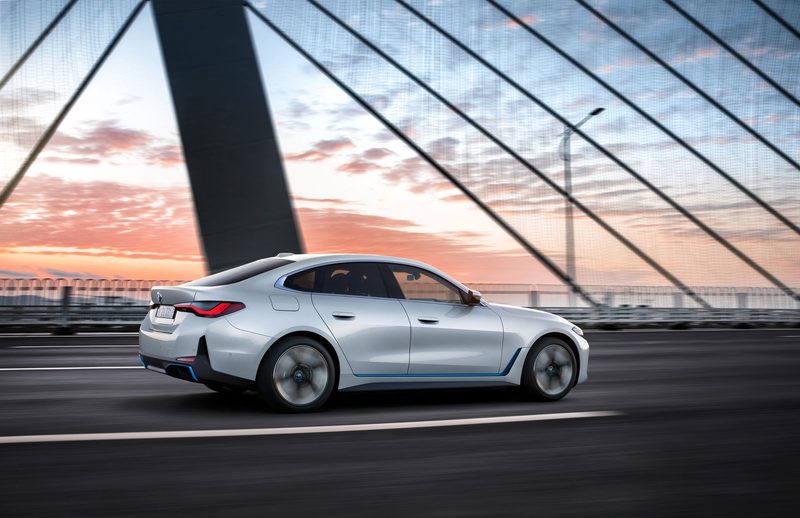2024 BMW i4 EV driving on the road.