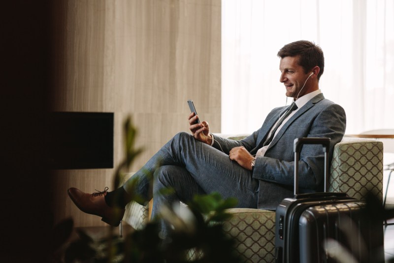 Executive making video call in airport lounge