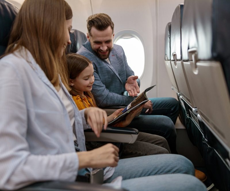 Parents and child seated on airplane together