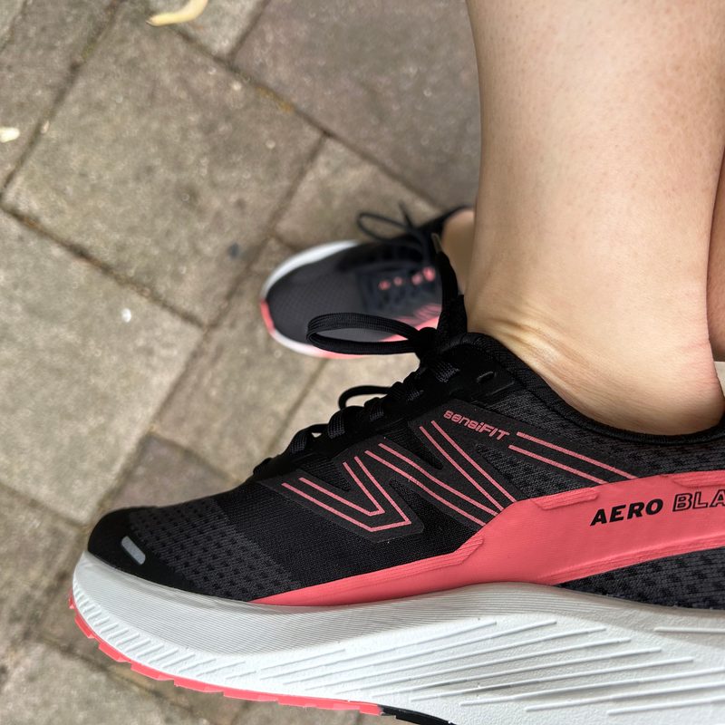 Salmon running shoes pigeon pose