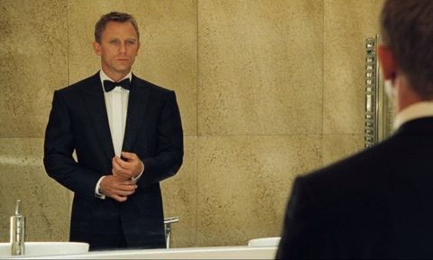 James Bond in a black dinner jacket looking in a mirror in Casino Royale