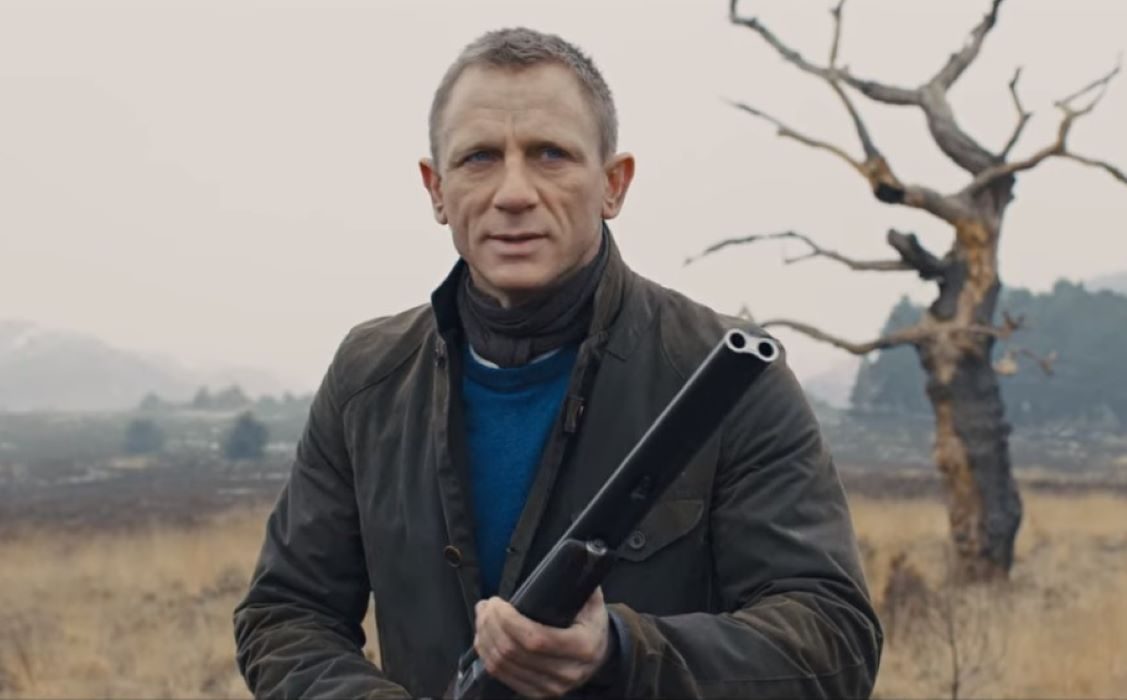 James Bond wearing layered outfit with waxed coat in Skyfall