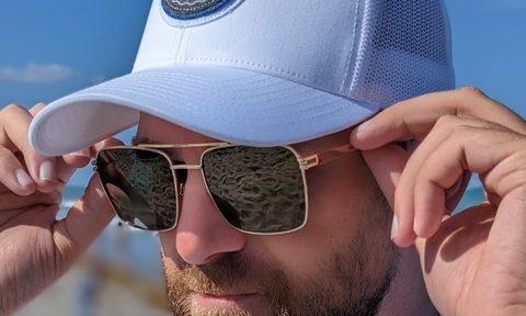 Man in Travis Mathew hat and Privé Revaux sunglasses