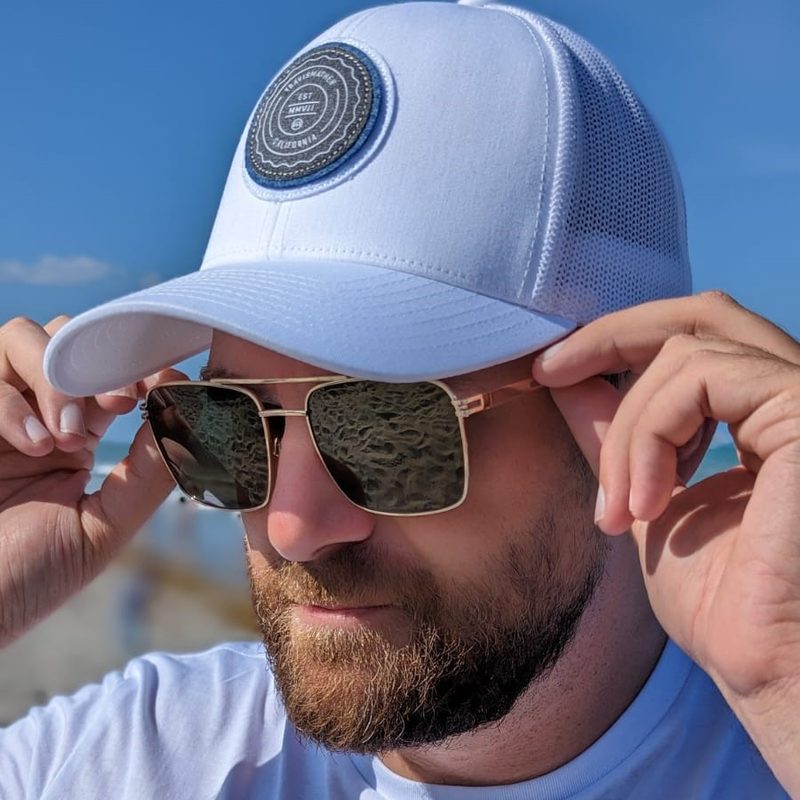 Man in Travis Mathew hat and Privé Revaux sunglasses