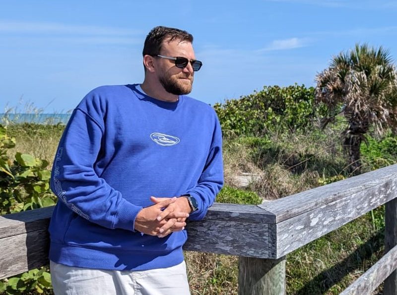 Man wearing Quicksilver sweatshirt and sunglasses