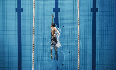 Man swimming freestyle.