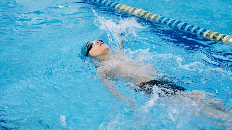 Man swimming backstroke