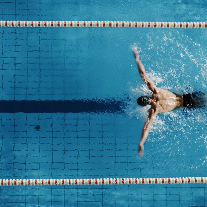 Man swimming butterfly stroke.