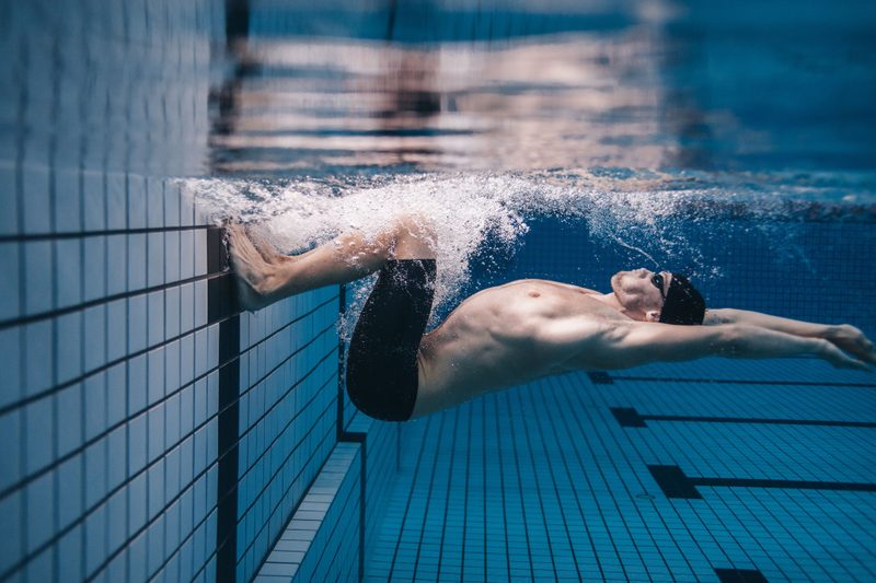 Man swimming in a pool.