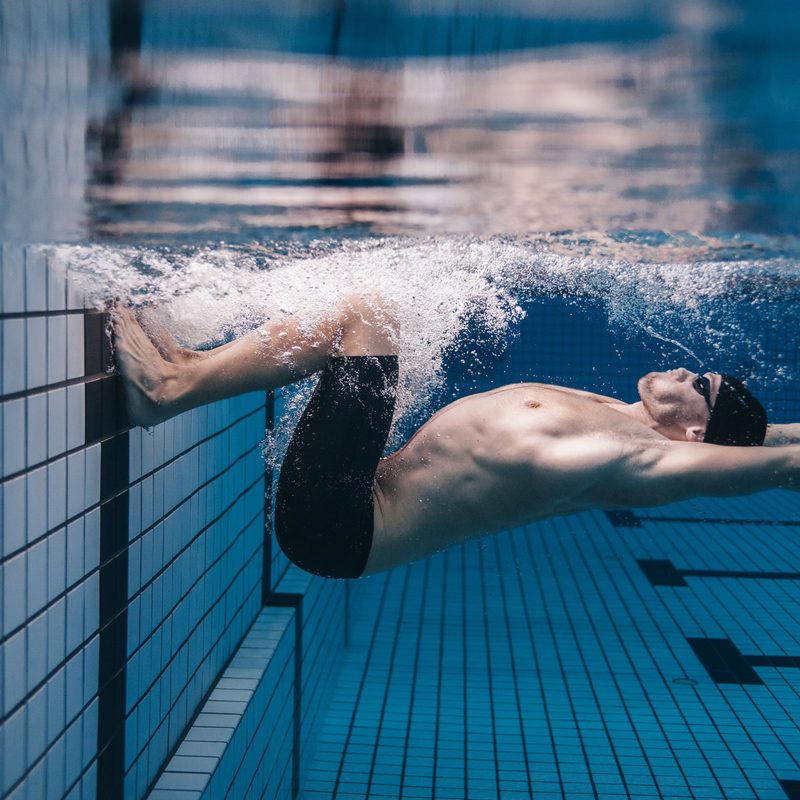 Man swimming in a pool.