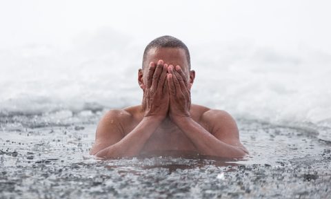 man swimming in ice