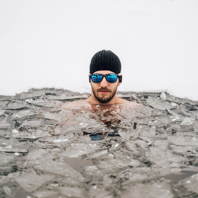 man swimming in ice