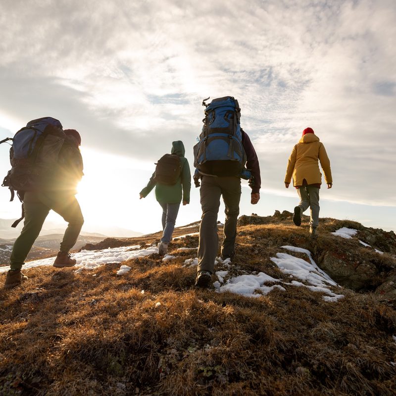 Group hiking at sunset