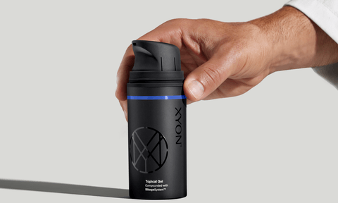 Xyon topical gel held by a doctor during product demo.