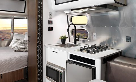 Kitchen and bedroom setup inside the Airstream Caravel 16RB travel trailer.