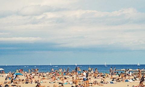 A crowded beach in the summer.