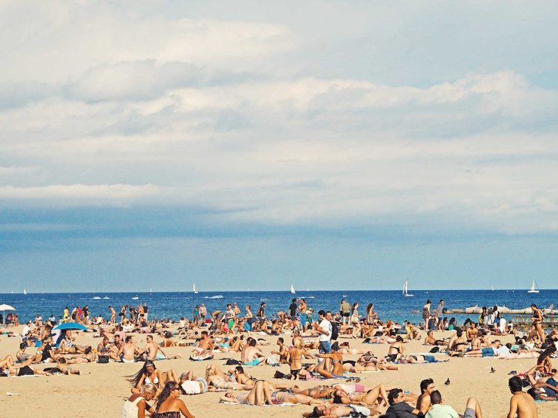 A crowded beach in the summer.