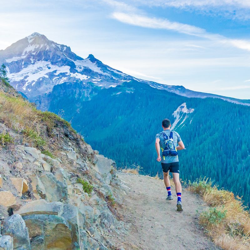 Trail runner jogging through mountains