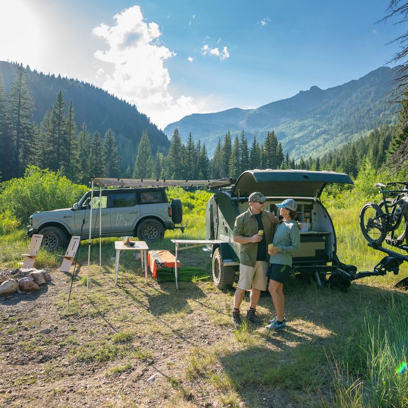Couple camping with the new 2023 Escapod TOPO2 Teardrop Trailer.