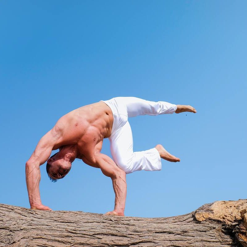 Man doing yoga pose outside.