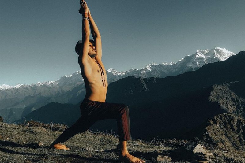 Man doing yoga outdoors