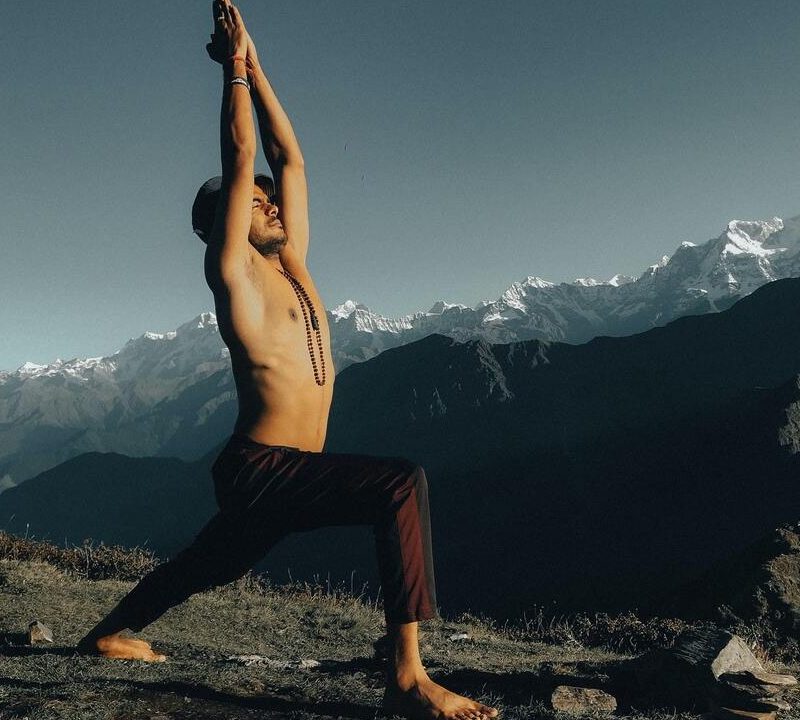 Man doing yoga outdoors.