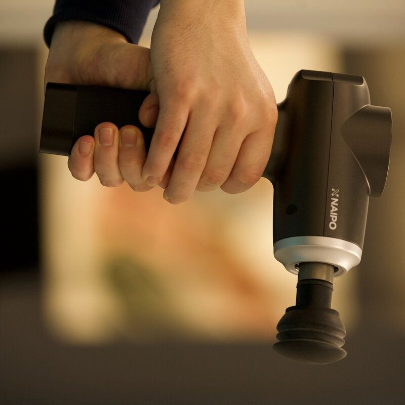 Person holding a massage gun.
