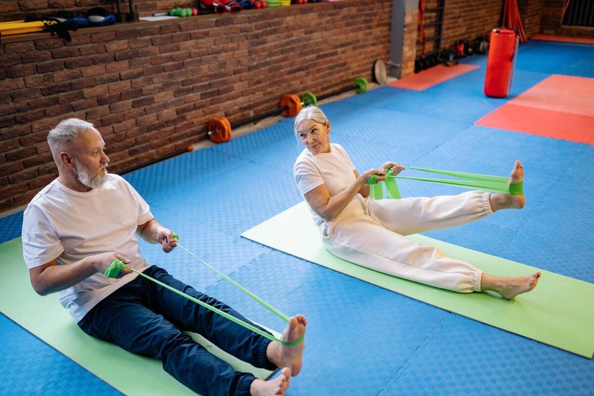 Older man and woman using resistance bands.