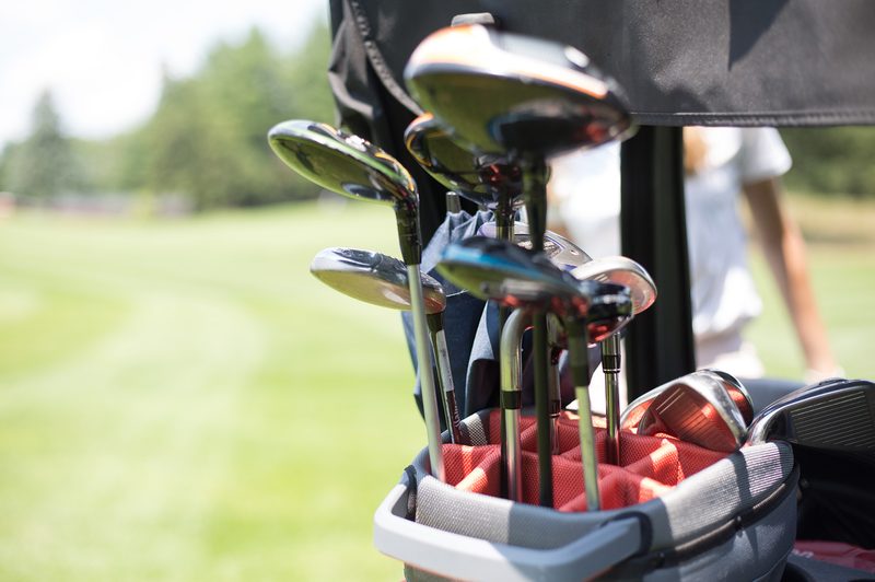 Golf clubs in a golf bag.
