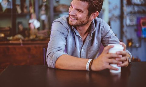 A man sitting drinking coffee.