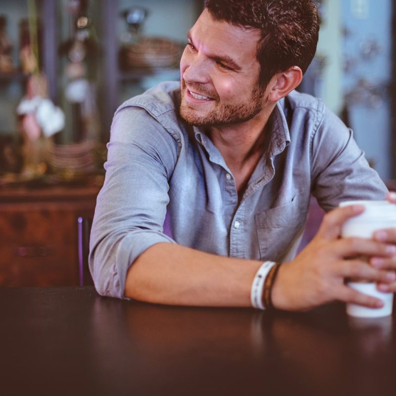 A man sitting drinking coffee.