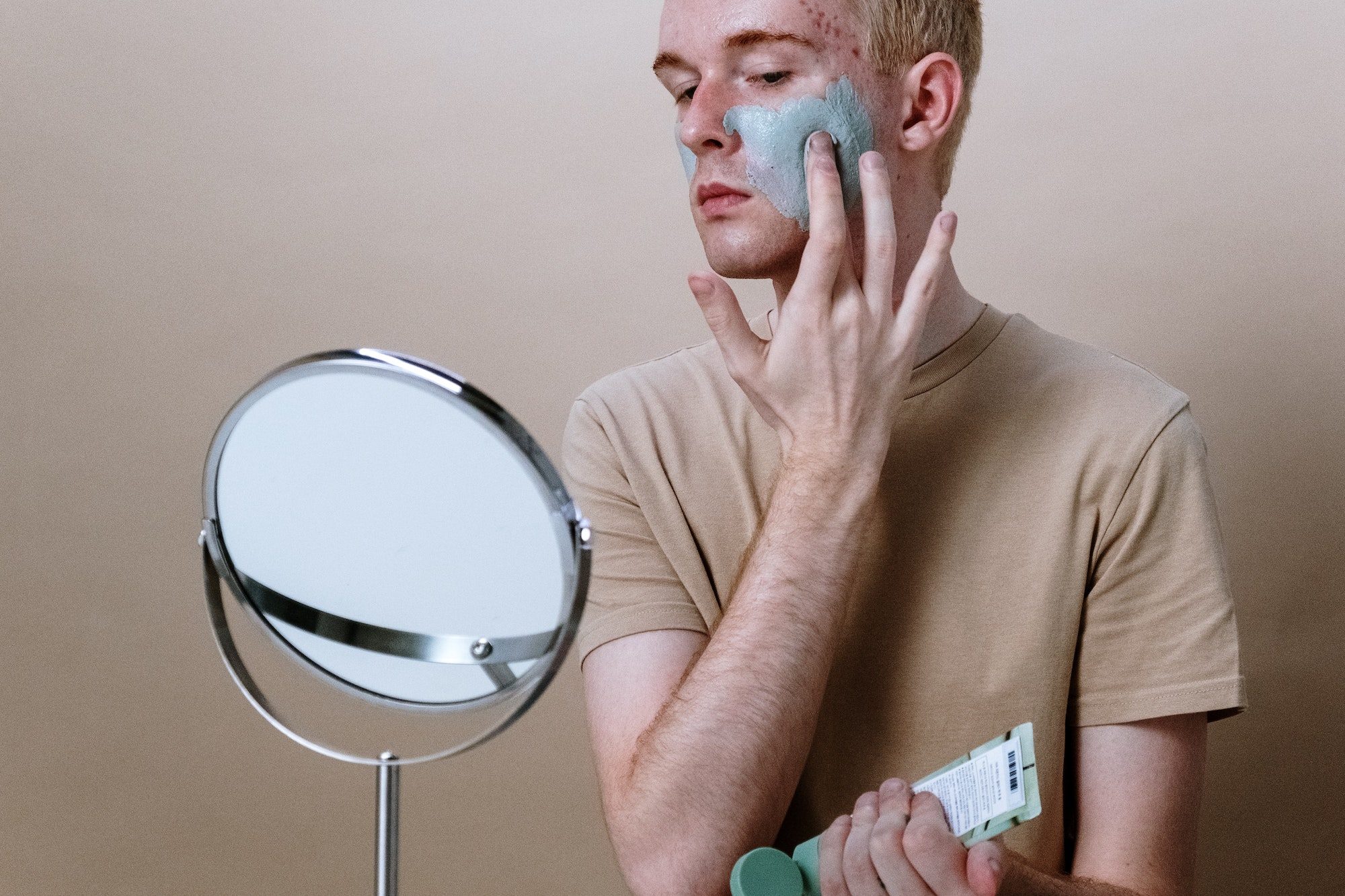 man with green acne cream