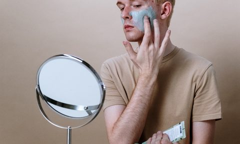man with green acne cream