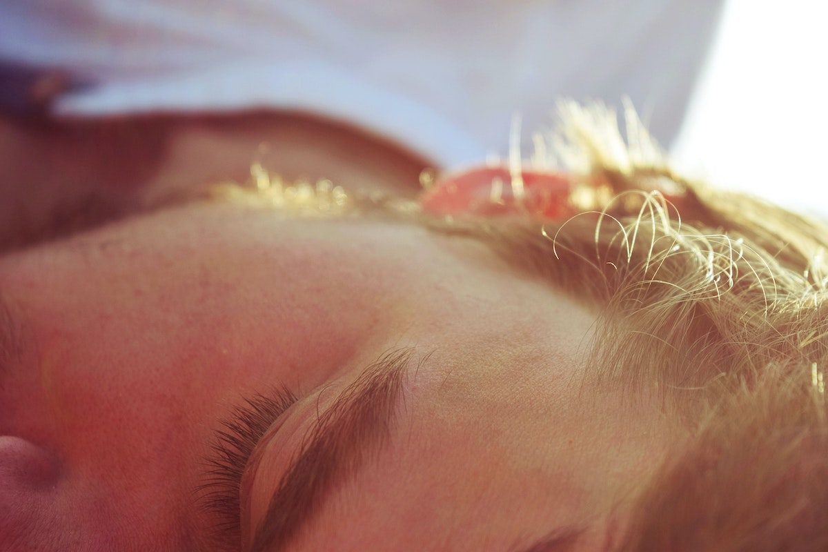 a man sleeping on his side, a close up