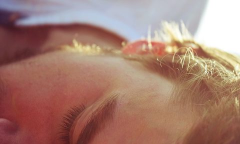 a man sleeping on his side, a close up